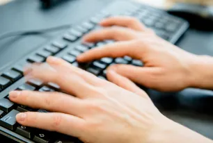 Das Foto zeigt eine Tastatur, auf der zwei Hände tippen